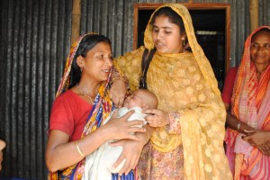 In Dergram village in Bangladesh, health worker Shefali Akhter (right) saved this baby from asphyxia moments after delivery by the mother (left). “The mother told me, ‘You saved my child.’ Now she loves me very much,” said Shefali. Photo: Amy Yee