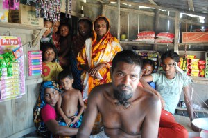 A tiger attacked this villager in Koyra, rendering him unable to farm and fish. The non-profit Relief International gave him and his family funds to open this small shop as another way to make money. Photo: Amy Yee